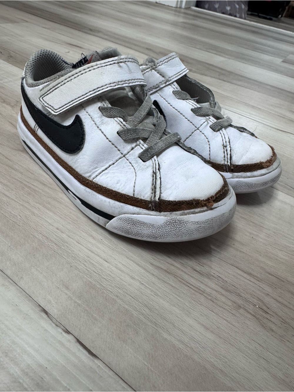 Nike Kids White Sneakers with Black Swoosh and Brown Trim